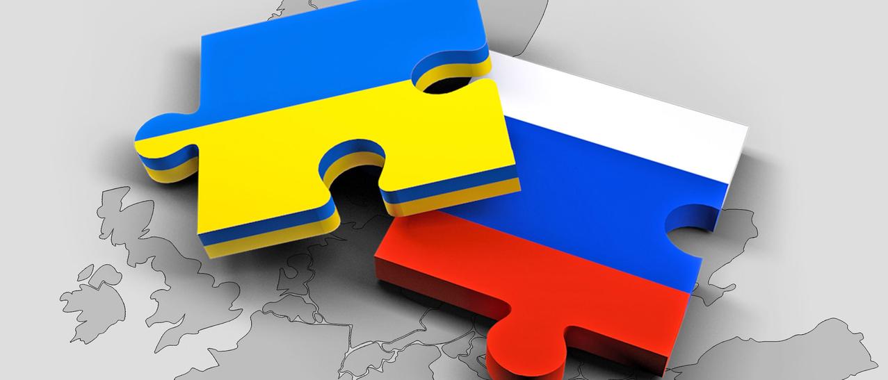 Carte géographique sur laquelle sont déposés des morceaux de casse-têtes aux couleurs des drapeaux de l'Ukraine et de la Russie.