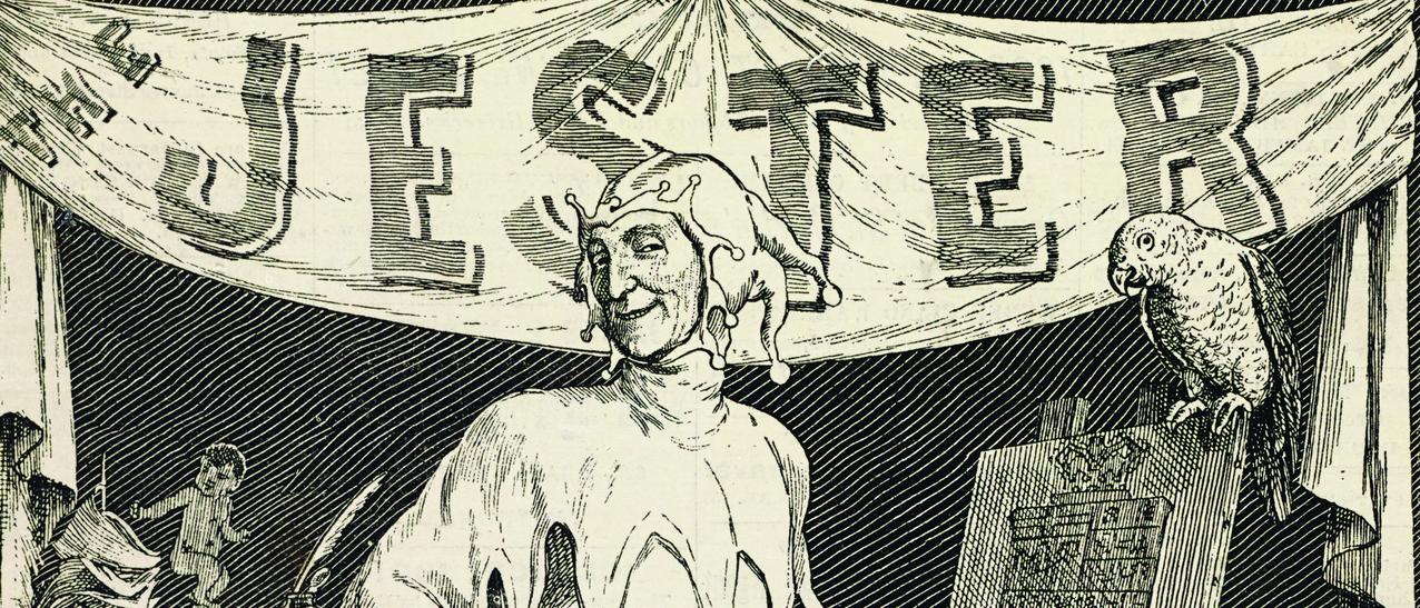 Un clown souriant pose devant une bannière sur laquelle est inscrite The Jester