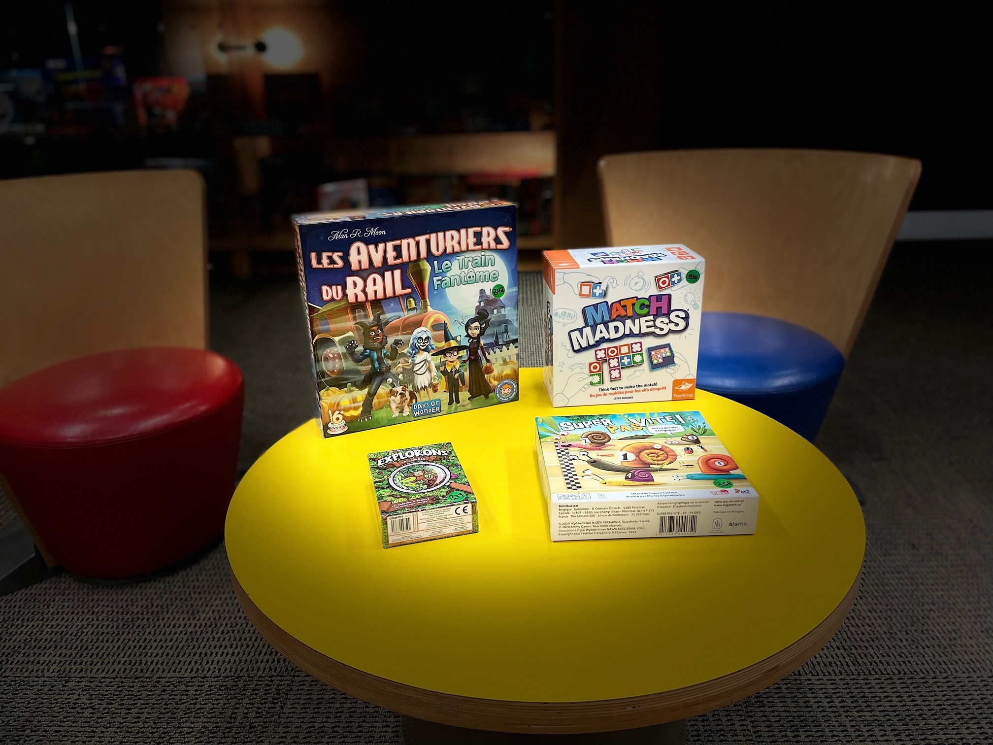 Photo en couleur de 4 jeux de société : Les aventuriers du rail - Le train fantôme, Match Madness, Explorons la jungle, Super pas vite.