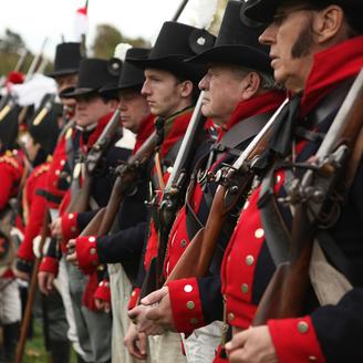 Hommes habillés en soldats du 18e siècle.