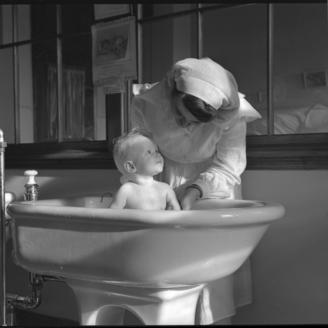 Infirmière donnant le bain à un jeune enfant