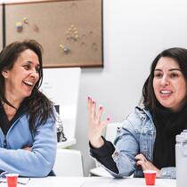 Deux femmes qui parlent et rient ensemble lors d'un atelier de conversation
